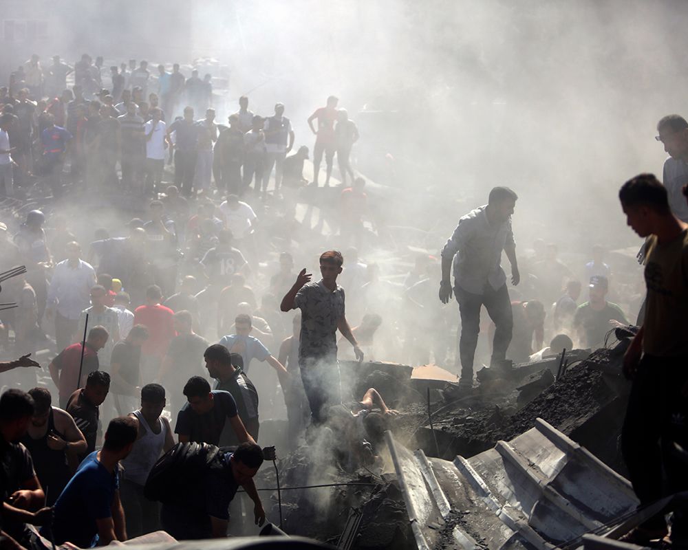 Palestinians inspect rubble of destroyed buildings