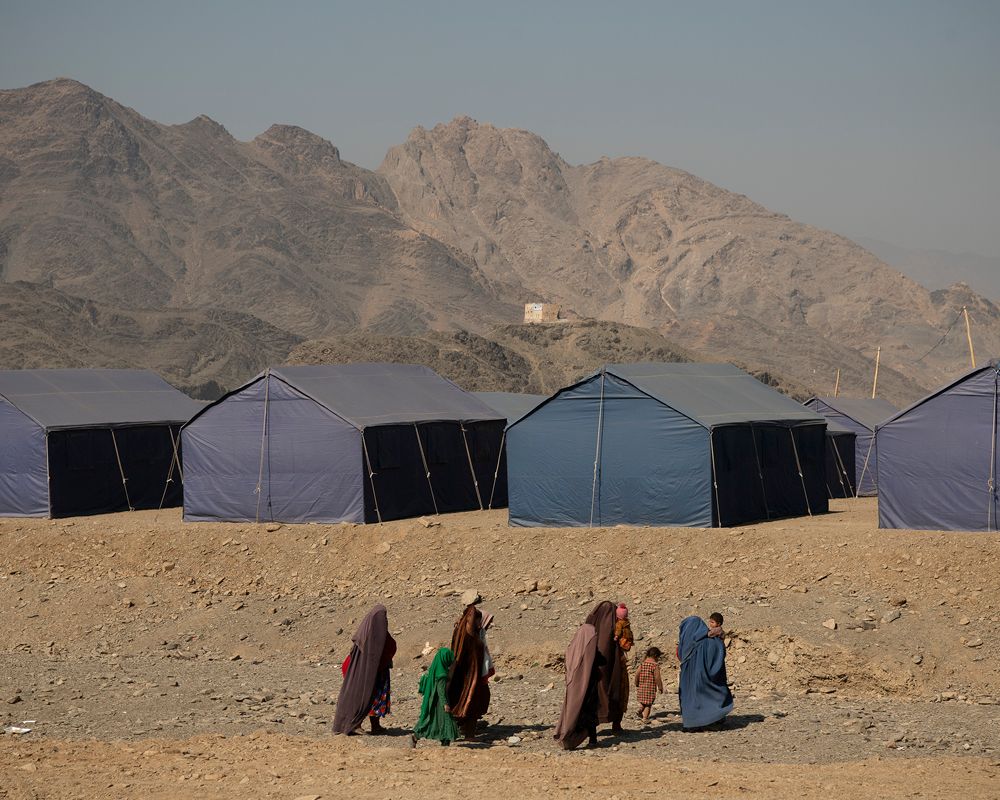 People walking in front of tent